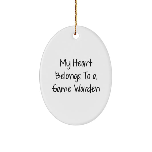 Funny Game Warden Gifts from Men - Oval Ornament for Christmas, 'My Heart Belongs To A Game Warden' Quote, Durable MDF with High-Gloss Finish - Gifts for Game Wardens, Men, and Friends - Image 1