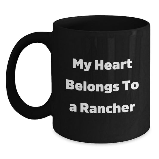 Funny Rancher Christmas Unique Gifts from Friends and Family for Men and Women Black Coffee Mug 'My Heart Belongs To A Rancher' - Main